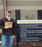 Dawson Kerns and Shelly Pate standing beside TN AgResearch Station sign