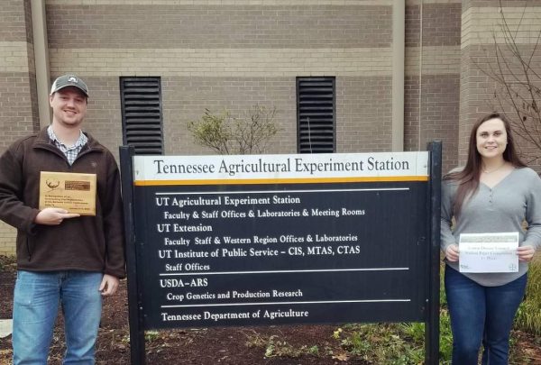 Dawson Kerns and Shelly Pate standing beside TN AgResearch Station sign