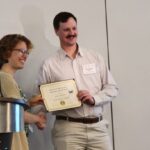 Dawson Kerns accepting the Mauro E. Martignoni award from the International Society for Invertebrate Pathology for his research on mechanism to Vip3Aa in corn earworm.