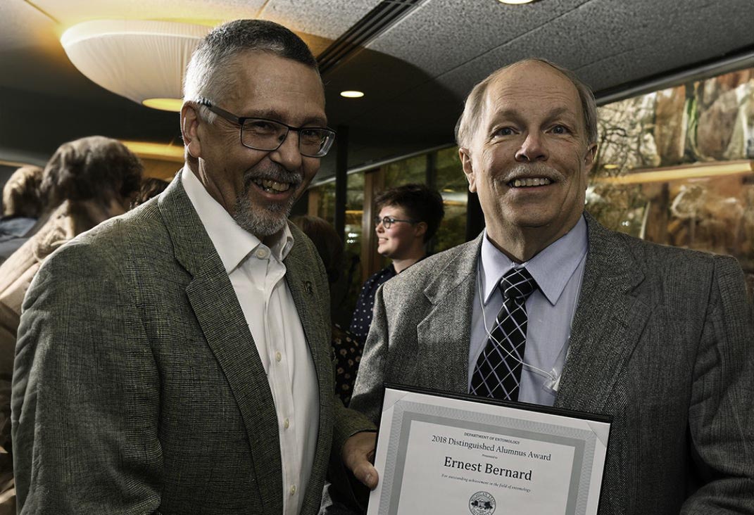 Ernest Bernard (right) receiving the 2018 Distinguished Alumnus Award from Entomology Chair Bill Ravlin.