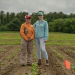Jessica Krob (left) standing in the field