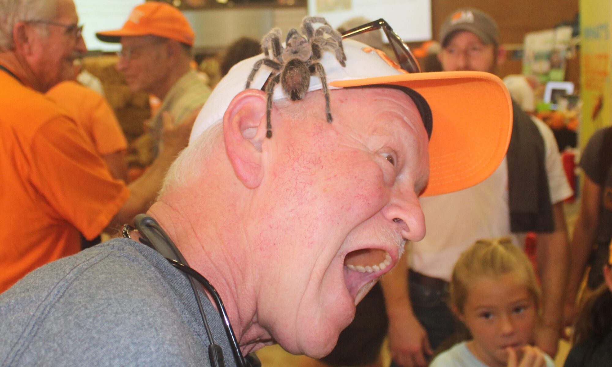 man with spider on baseball cap